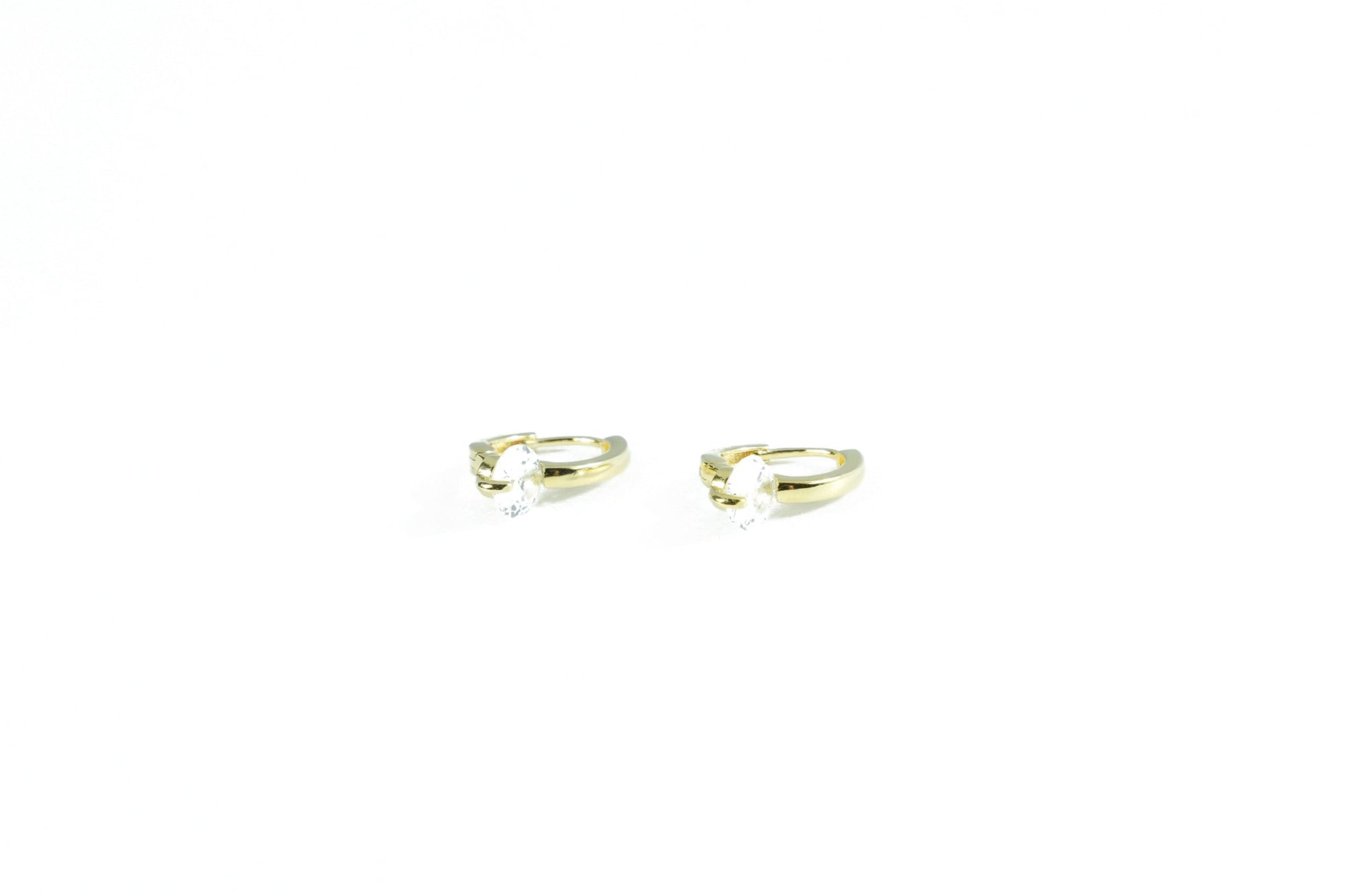 gold earring with a striking diamond ring
